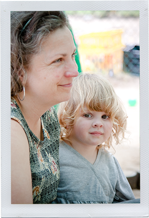 Photograph: A child looks back at the camera while a child care professional looks on. (Photograph by Alex Lazara)