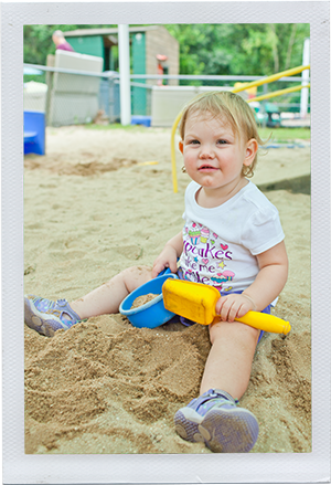 Photograph: A toddler playing with a shovel and pail in a sandbox. (Photograph by Alex Lazara)